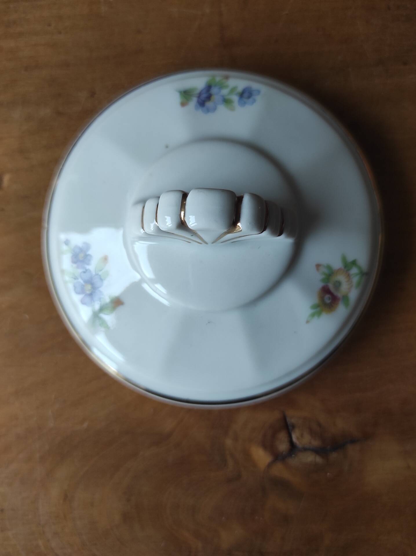 Antique porcelain sugar bowl with a decagonal base.