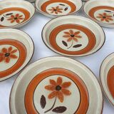 Set 11 plates 1970 Revernay Sarreguemines orange and brown on sandstone background