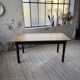 Oak farmhouse table with turned black legs.