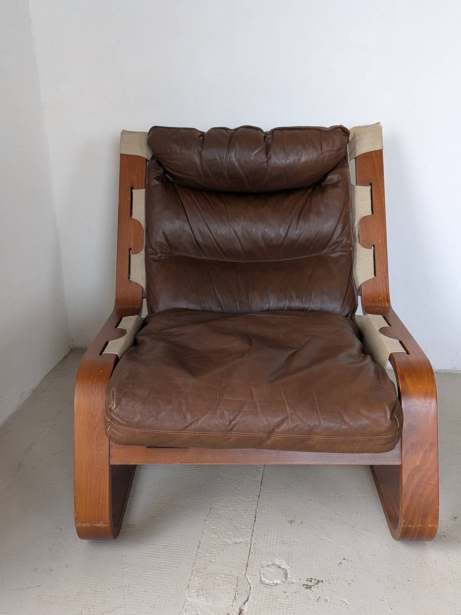 Leather and wood armchair, brutalist style.