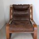 Leather and wood armchair, brutalist style.