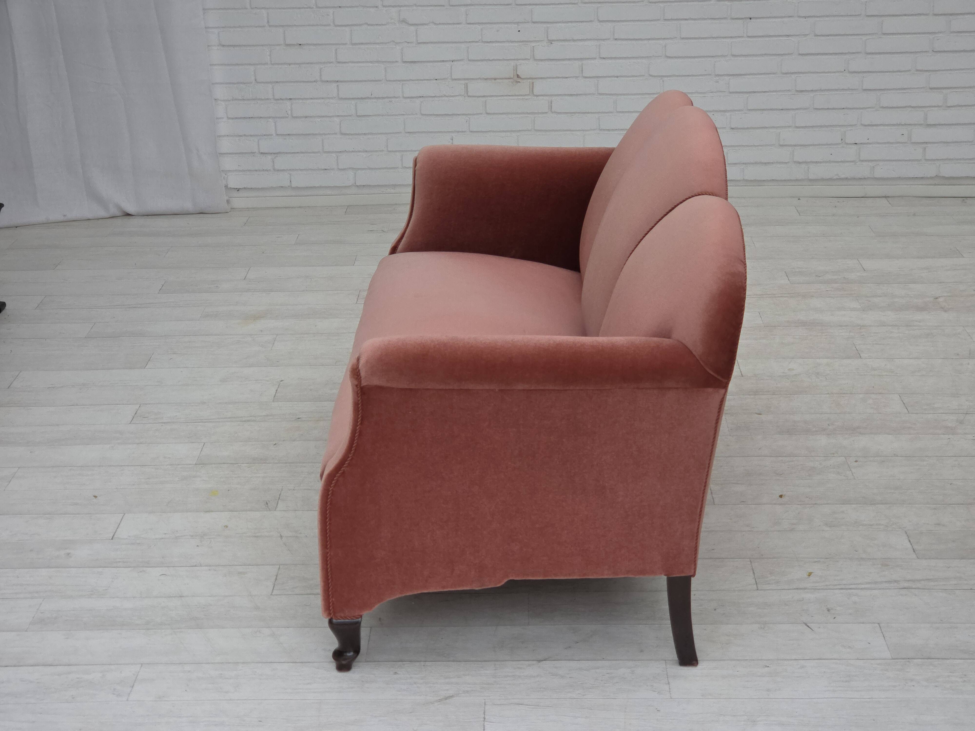 1950s, Danish 2-seater sofa, salmon pink furniture velour, oak wood legs.