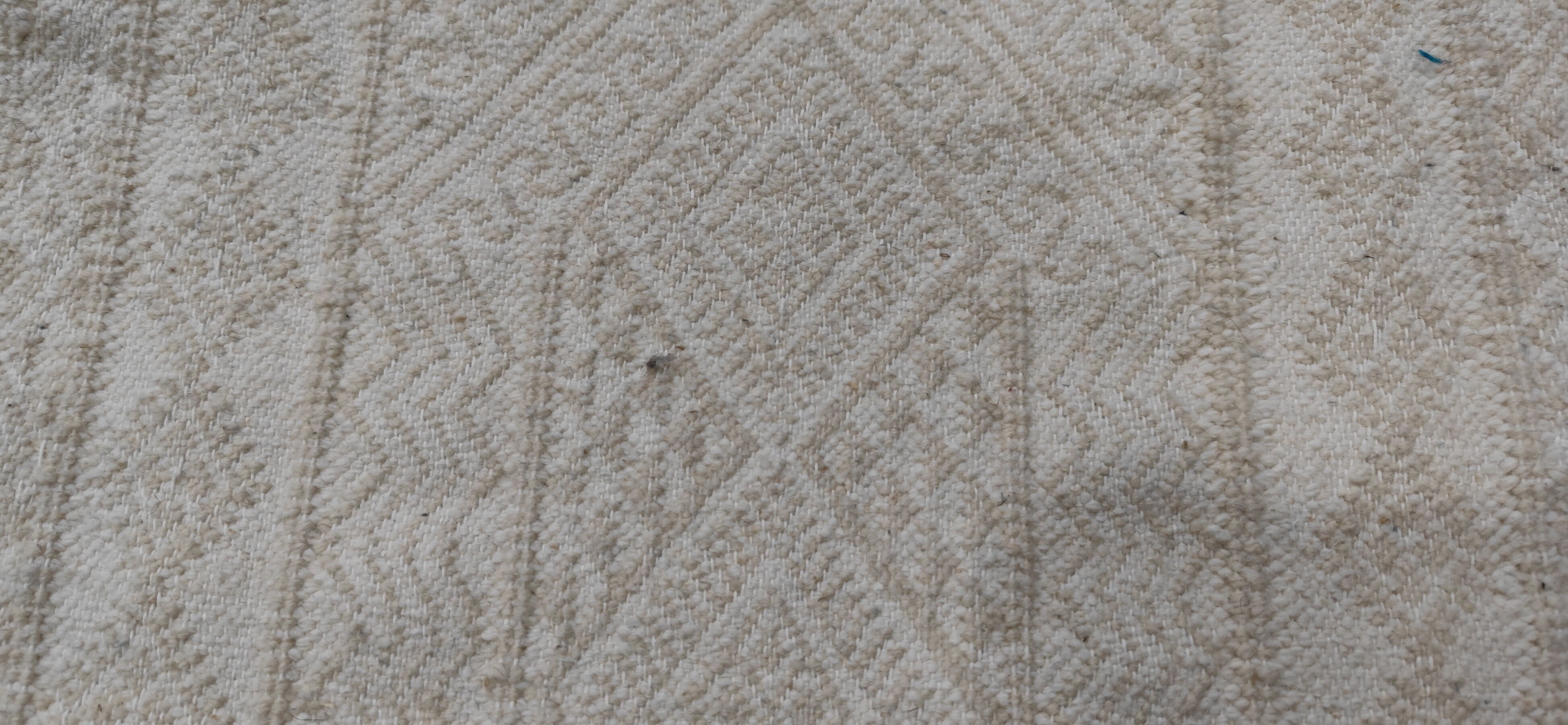 Hand-woven rug in natural wool