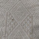Hand-woven rug in natural wool