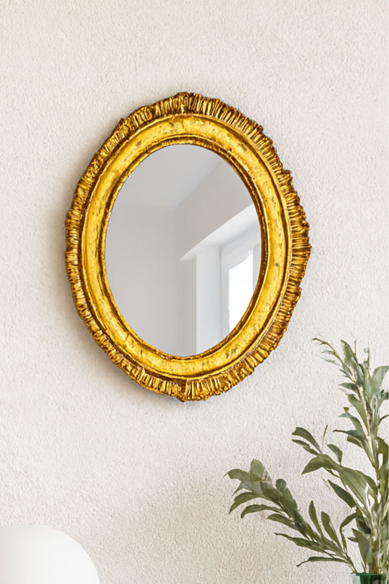 Antique oval mirror in gilded wood