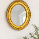 Antique oval mirror in gilded wood