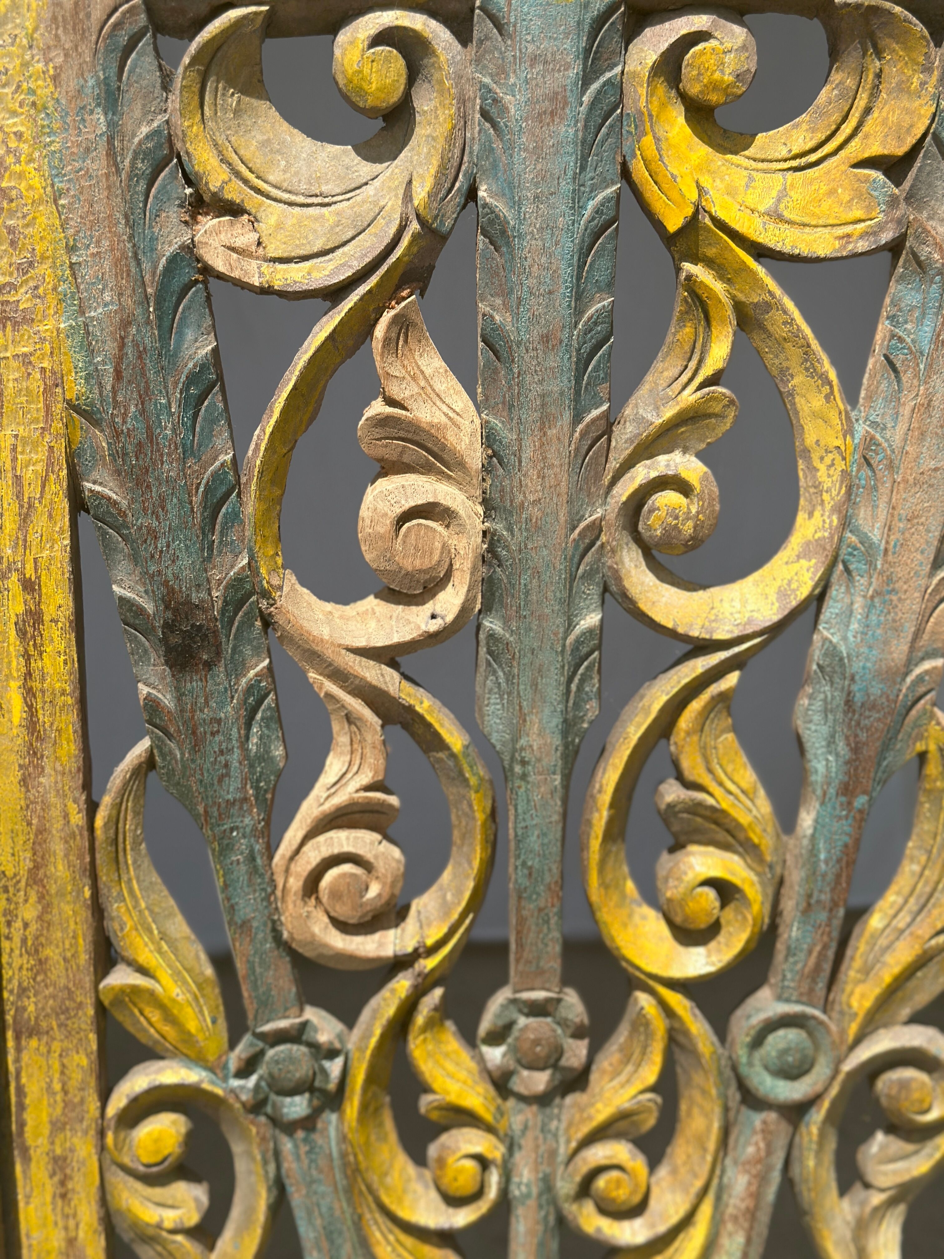 Rectangular Indonesian construction element with blue and yellow plant in carved wood