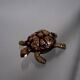 Golden brass turtle in decorative ashtray