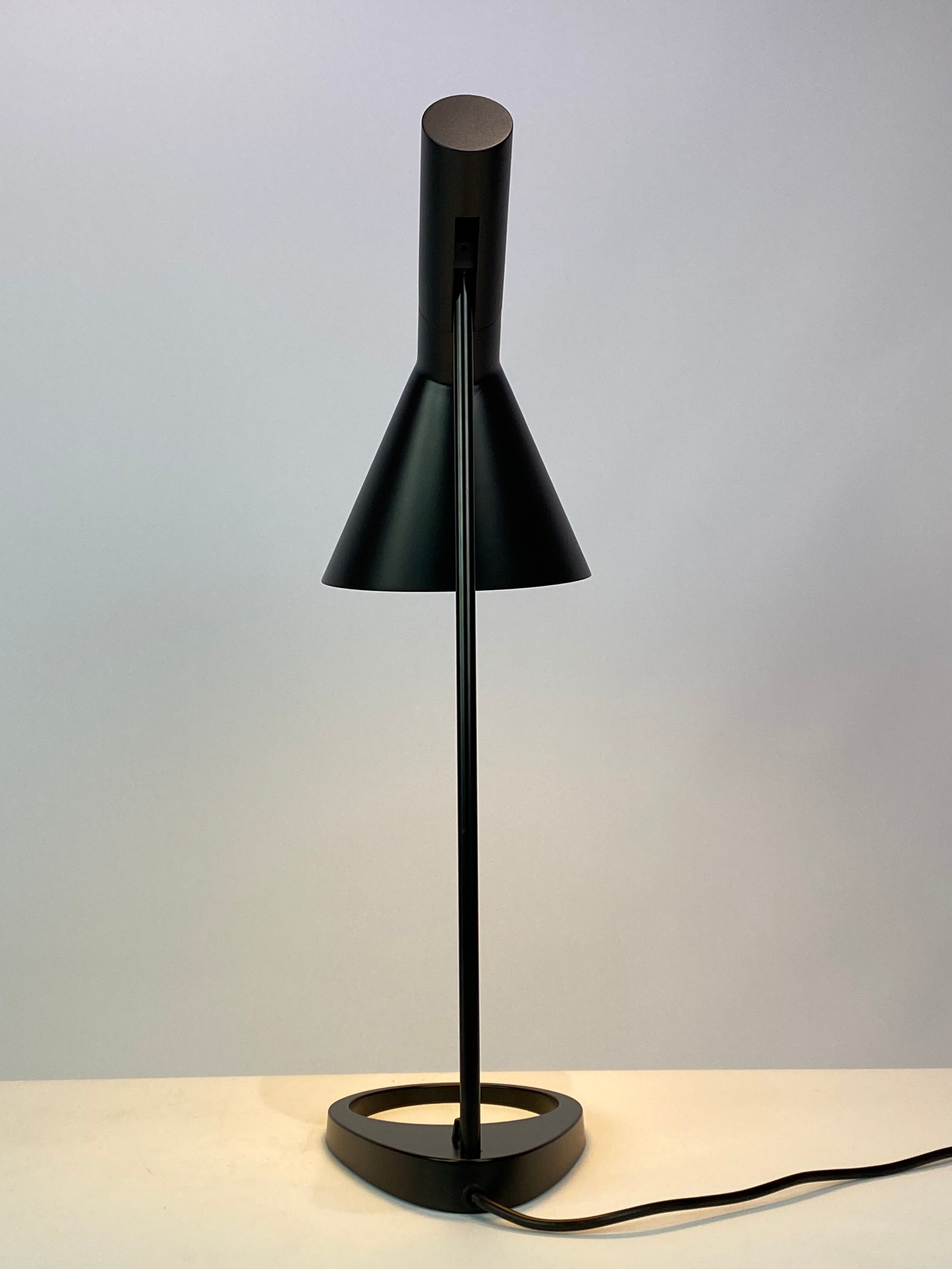 Black table lamp designed by Arne Jacobsen and manufactured by Louis Poulsen