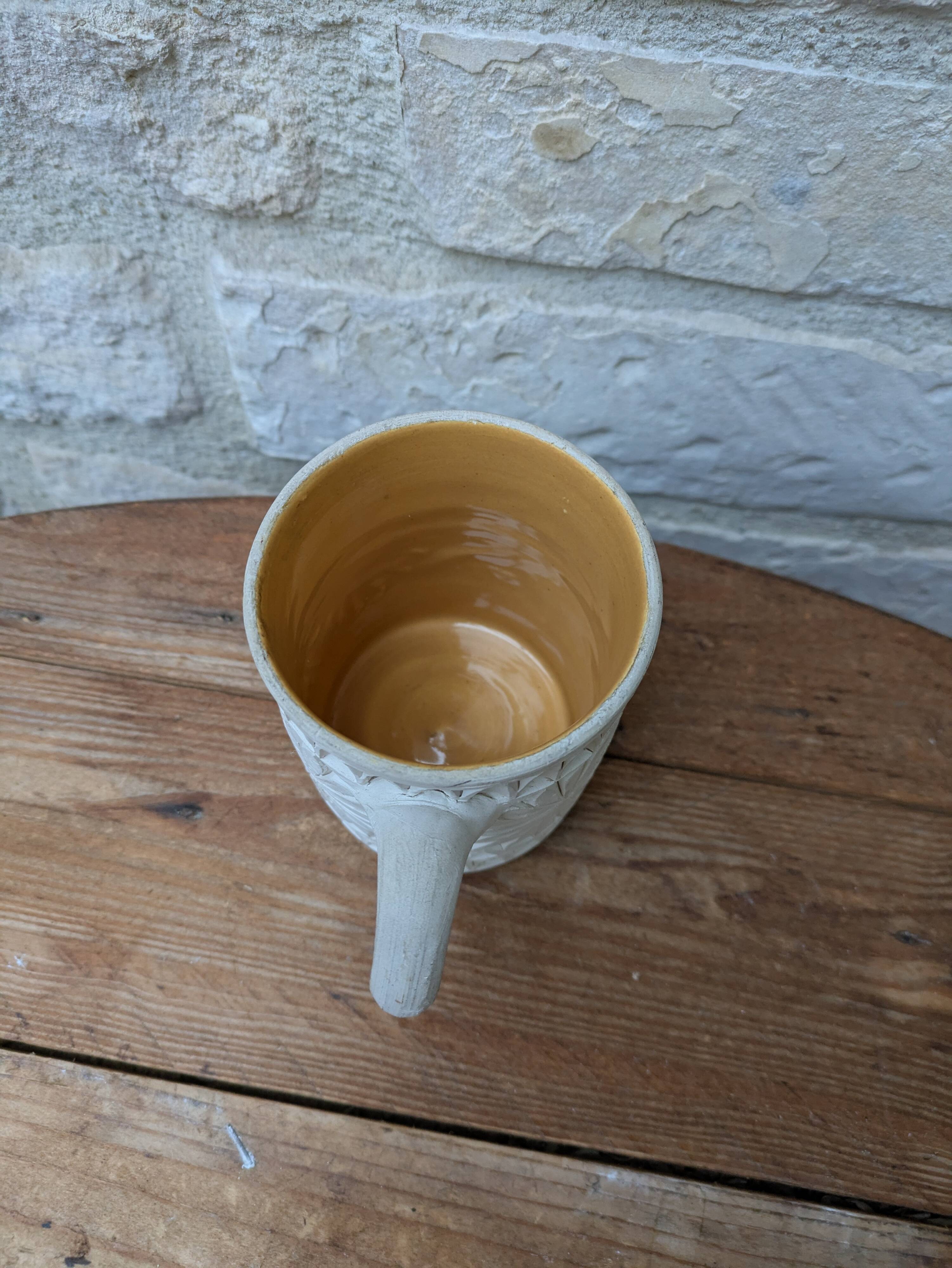 Old terracotta mug with glazed interior
