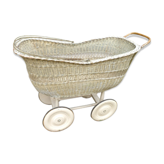 Vintage rattan cradle on wheels