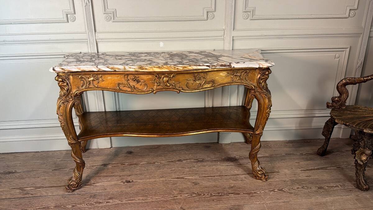 Golden wooden console, four legs adorned with sea monsters, purple breccia marble, around 1900.