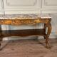 Golden wooden console, four legs adorned with sea monsters, purple breccia marble, around 1900.