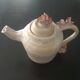 Vintage teapot with relief coral decoration.