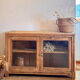 Old wooden buffet with a glass front in raw wood