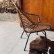 Rattan armchair and black metal base 1960