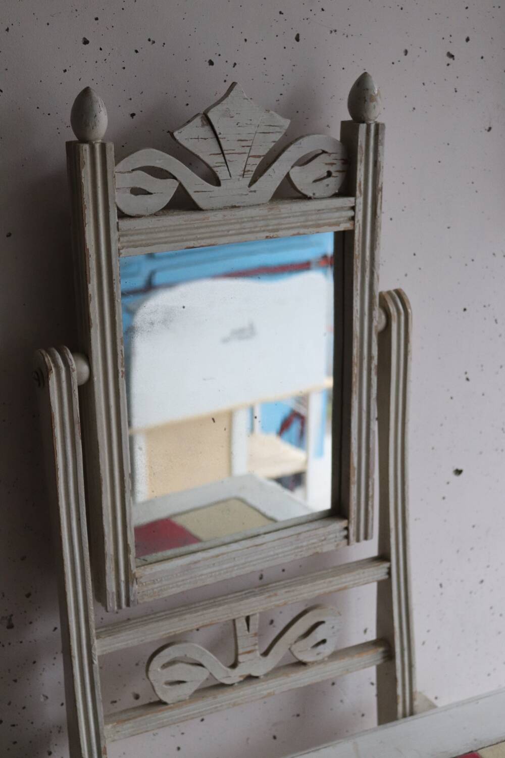 Small antique folding wooden dressing table with tiles and a mercury mirror.