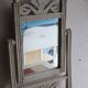 Small antique folding wooden dressing table with tiles and a mercury mirror.