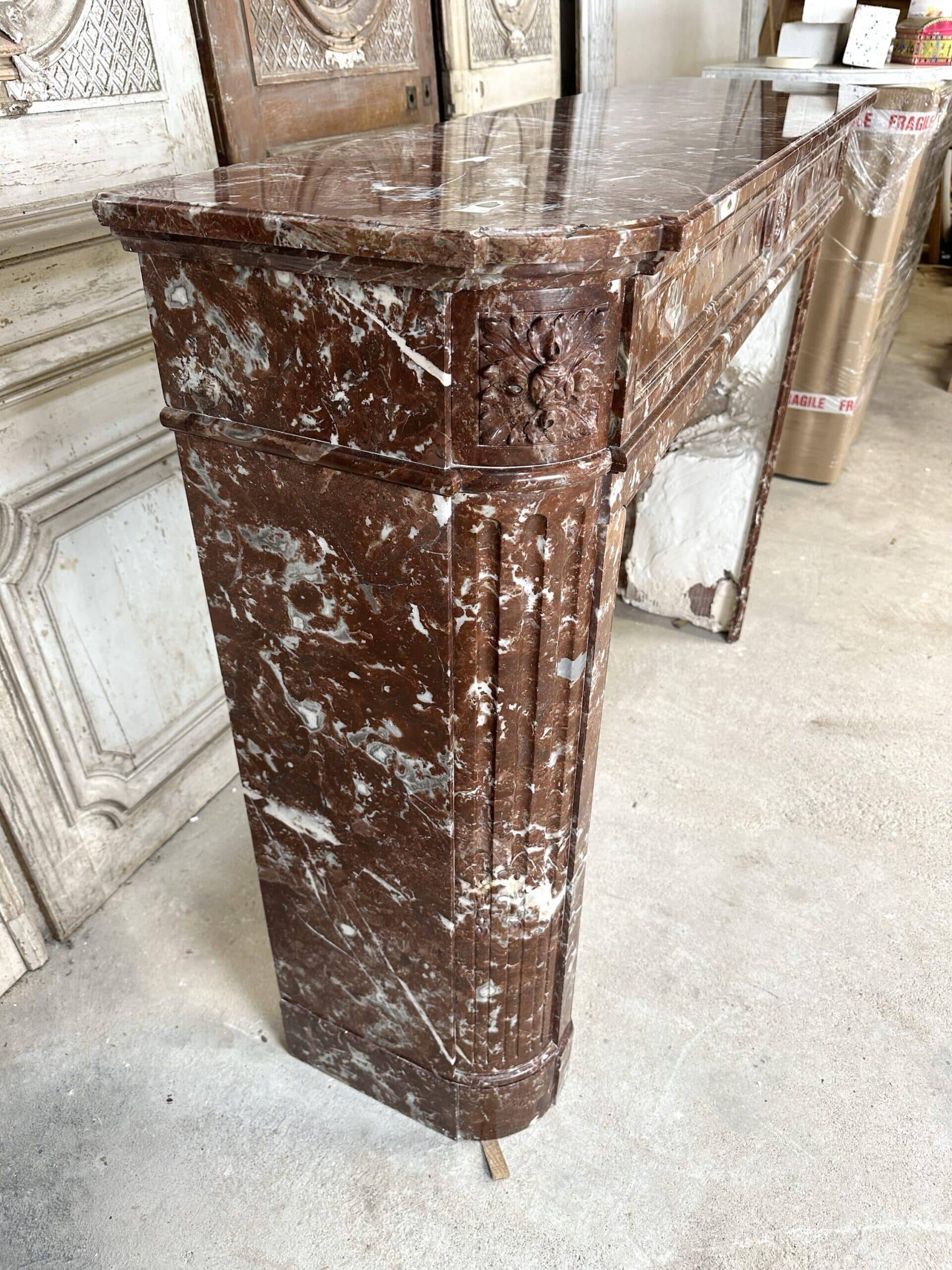 Red marble fireplace in the Louis XVI style, late 19th century