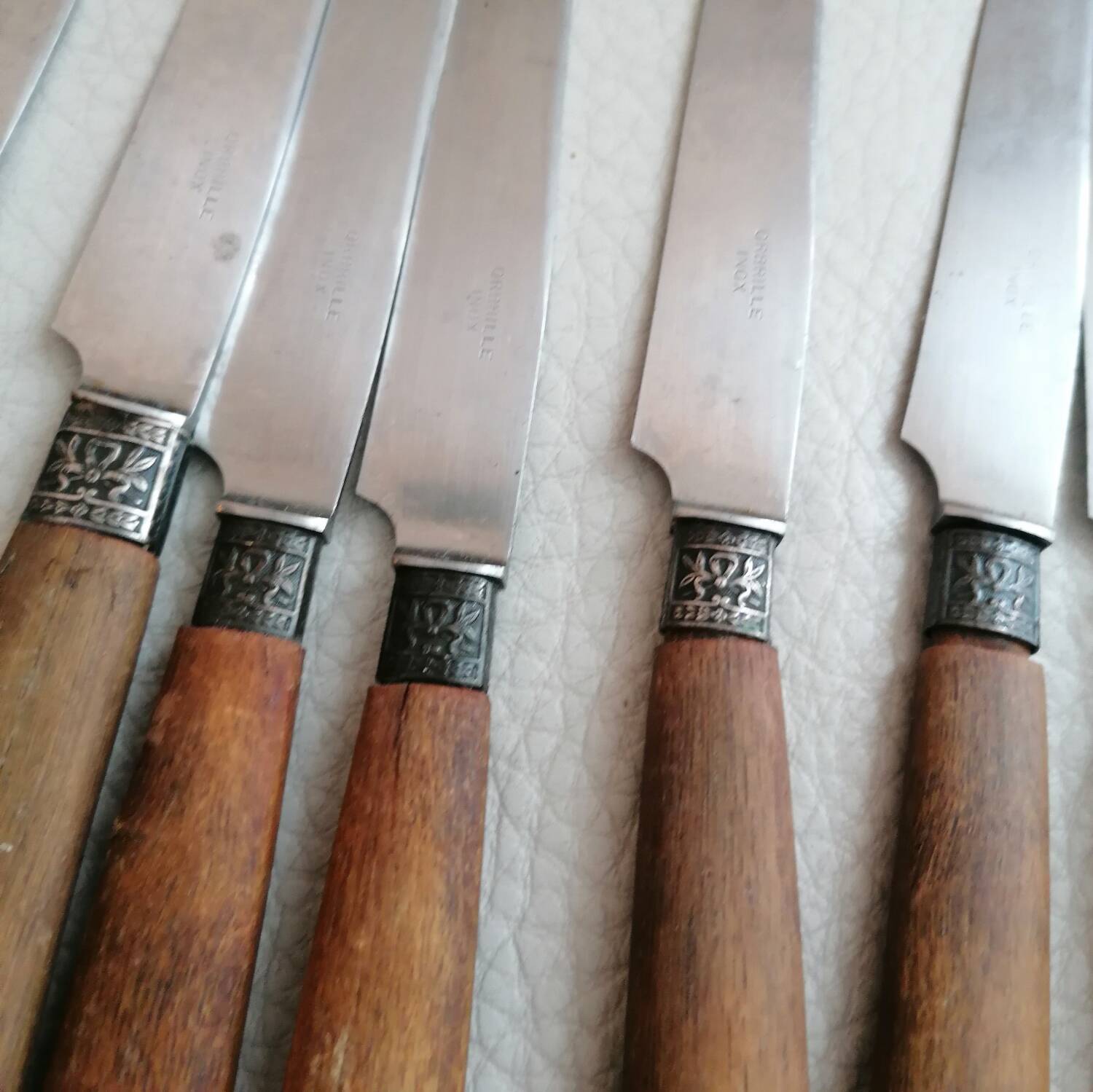 Old table knives and dessert knives, wooden handles, stainless steel blades