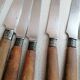 Old table knives and dessert knives, wooden handles, stainless steel blades