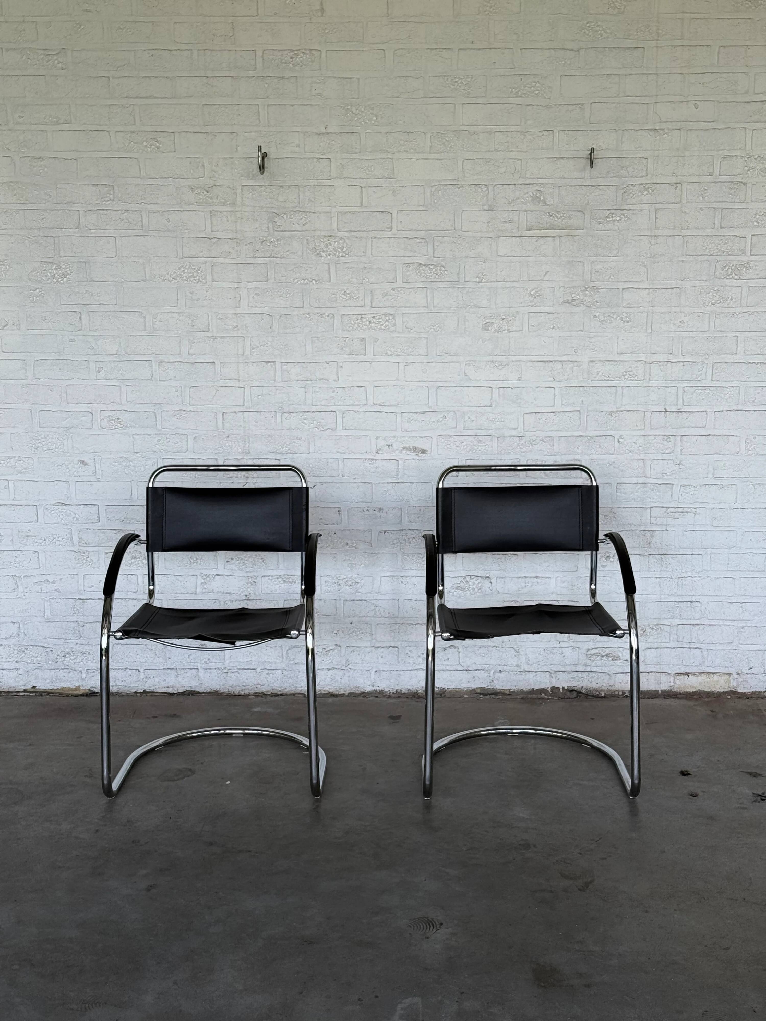 Vintage cantilever chairs in black saddle leather and chrome.