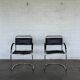 Vintage cantilever chairs in black saddle leather and chrome.