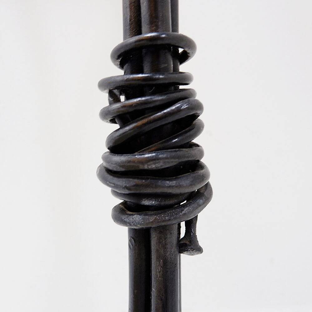 Large wrought iron candelabrum with an abstract design and three candle holders.