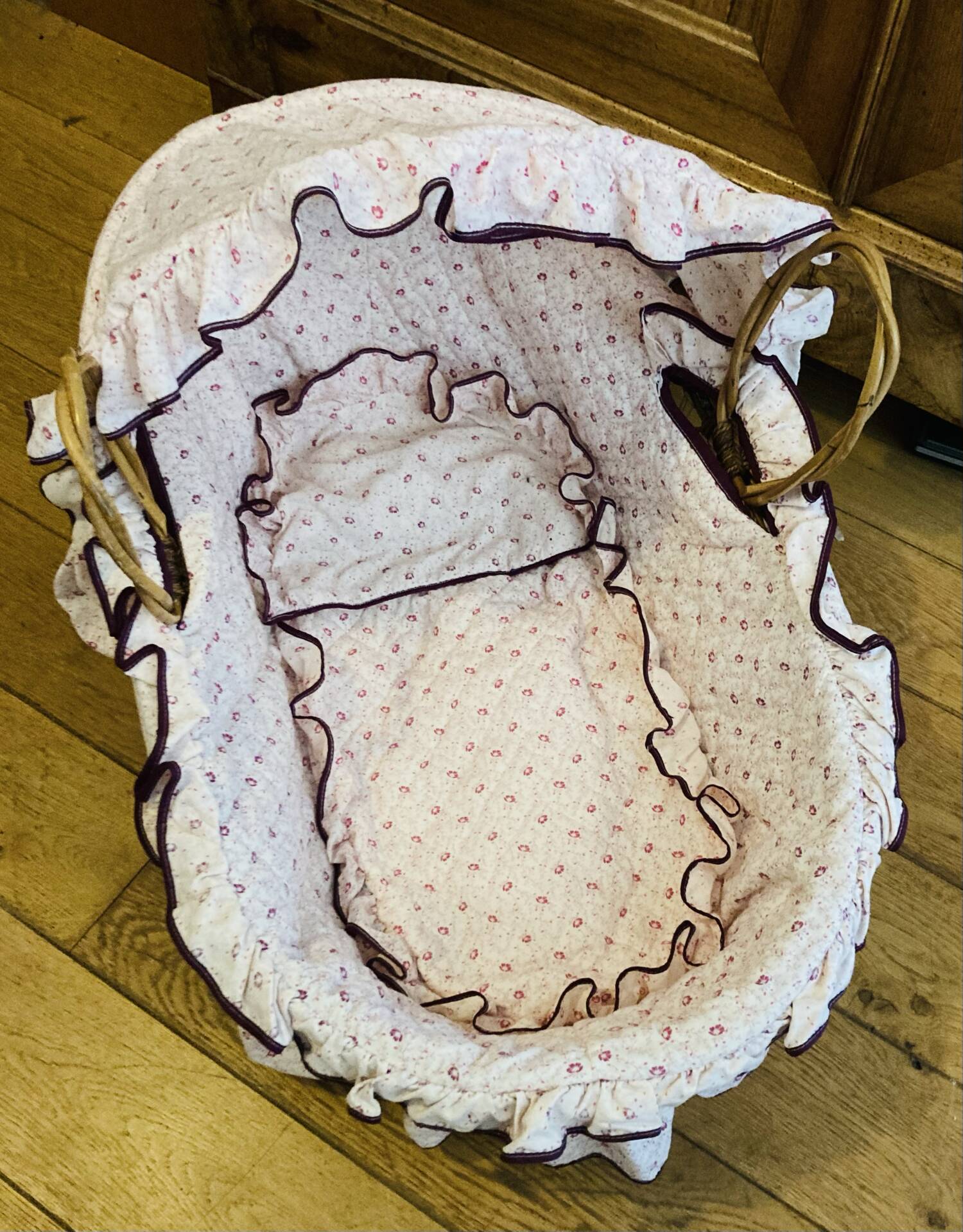 1960s wicker cradle with mattress and drapes.