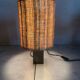 Small modernist table lamp with hand-woven shade.