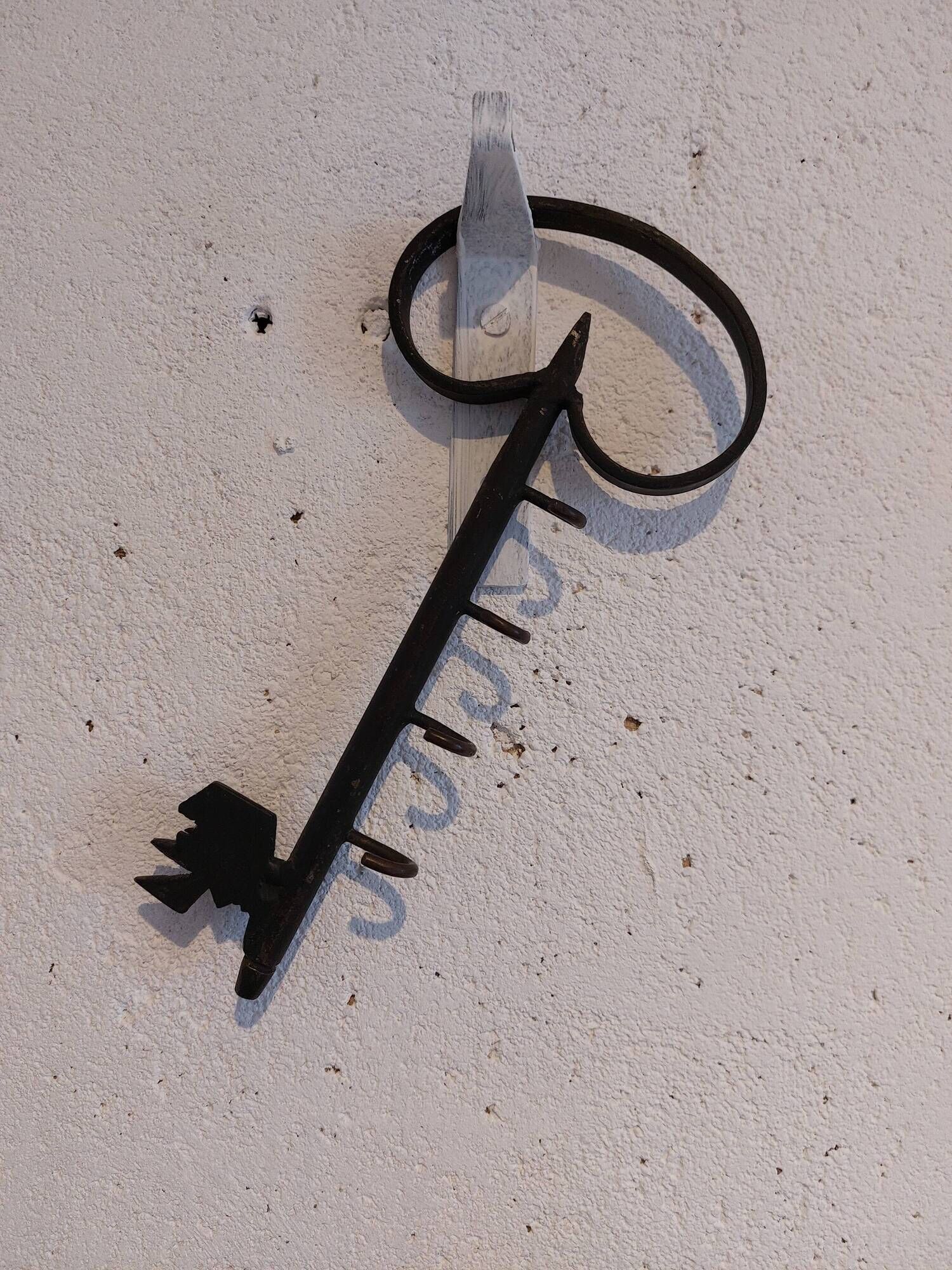 Old wall key holder in the shape of a vintage metal key 4 hooks
