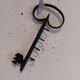Old wall key holder in the shape of a vintage metal key 4 hooks
