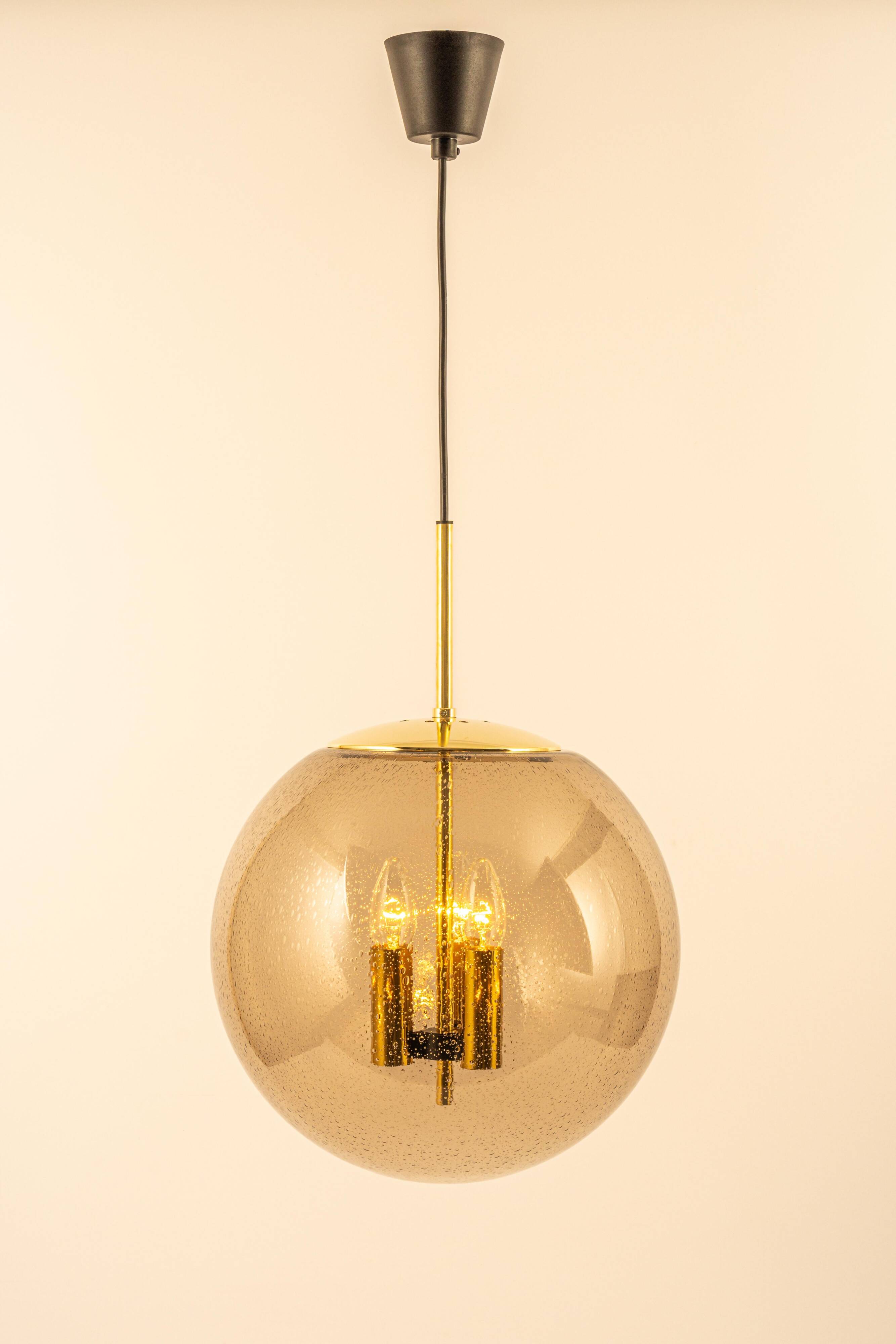 Large Limburg pendant light in brass with smoked glass ball, Germany, 1970s.