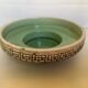 Green ceramic candle holder with a frieze