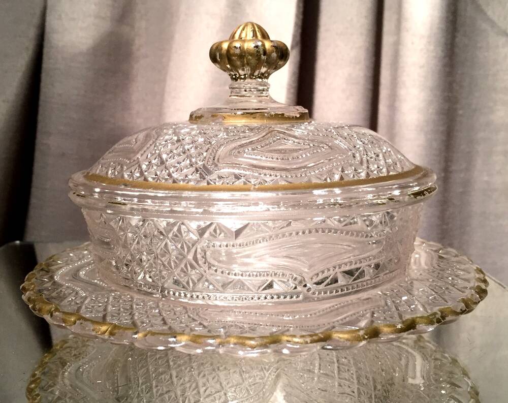 Butter dish or candy dish in pressed glass molded with golden rim