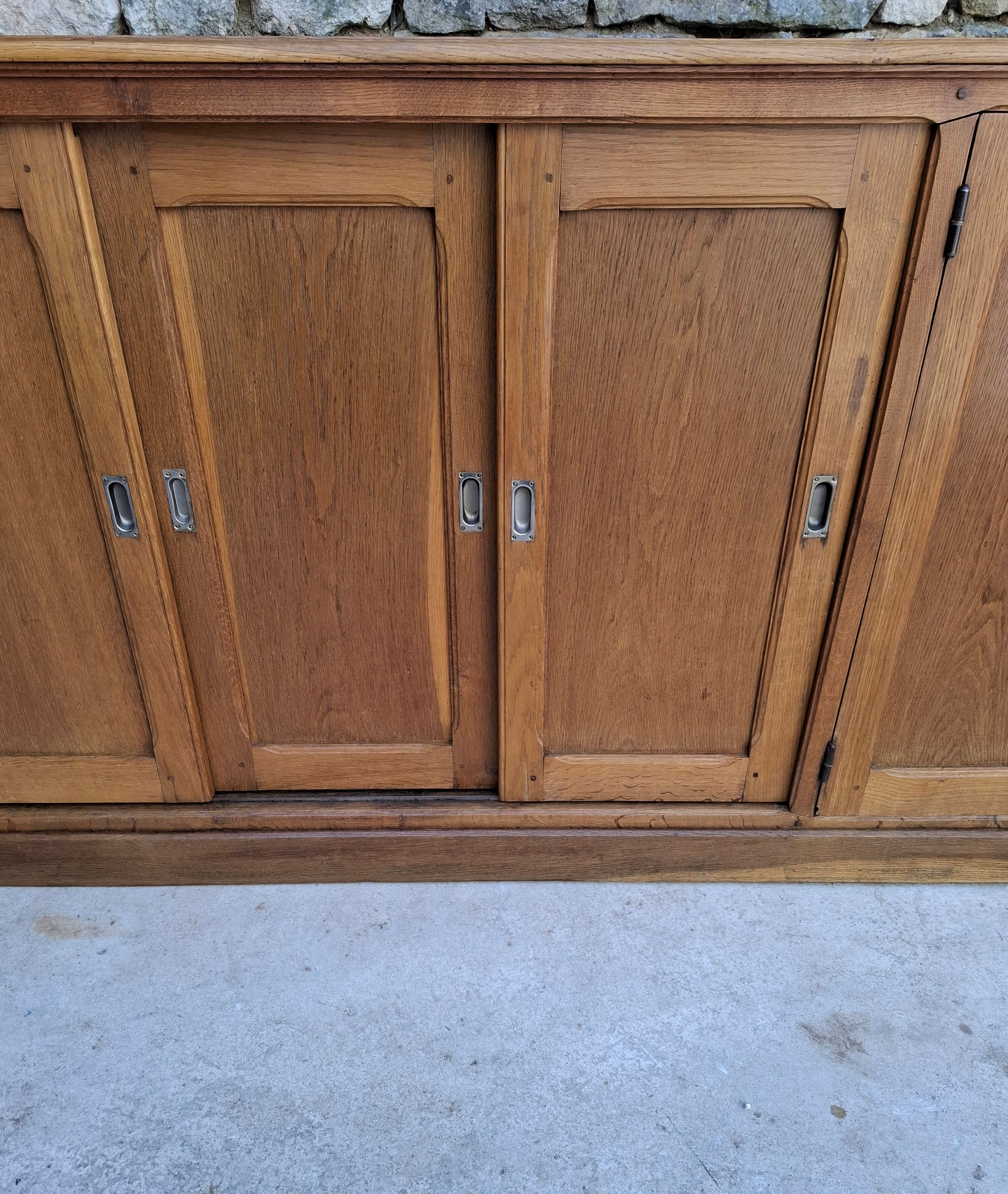 Oak workshop furniture with sliding doors.