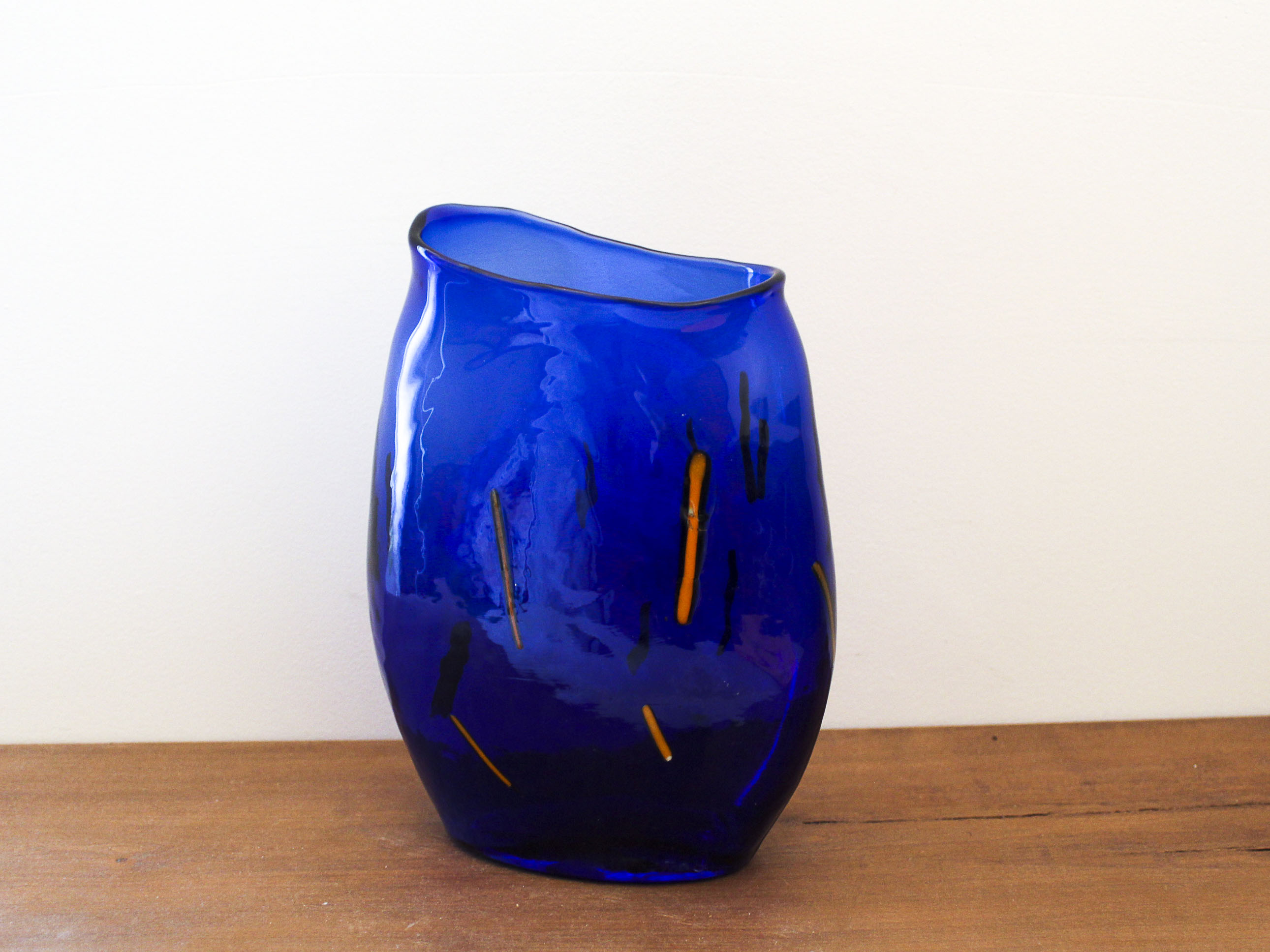 Blue blown glass vase and orange inclusion
