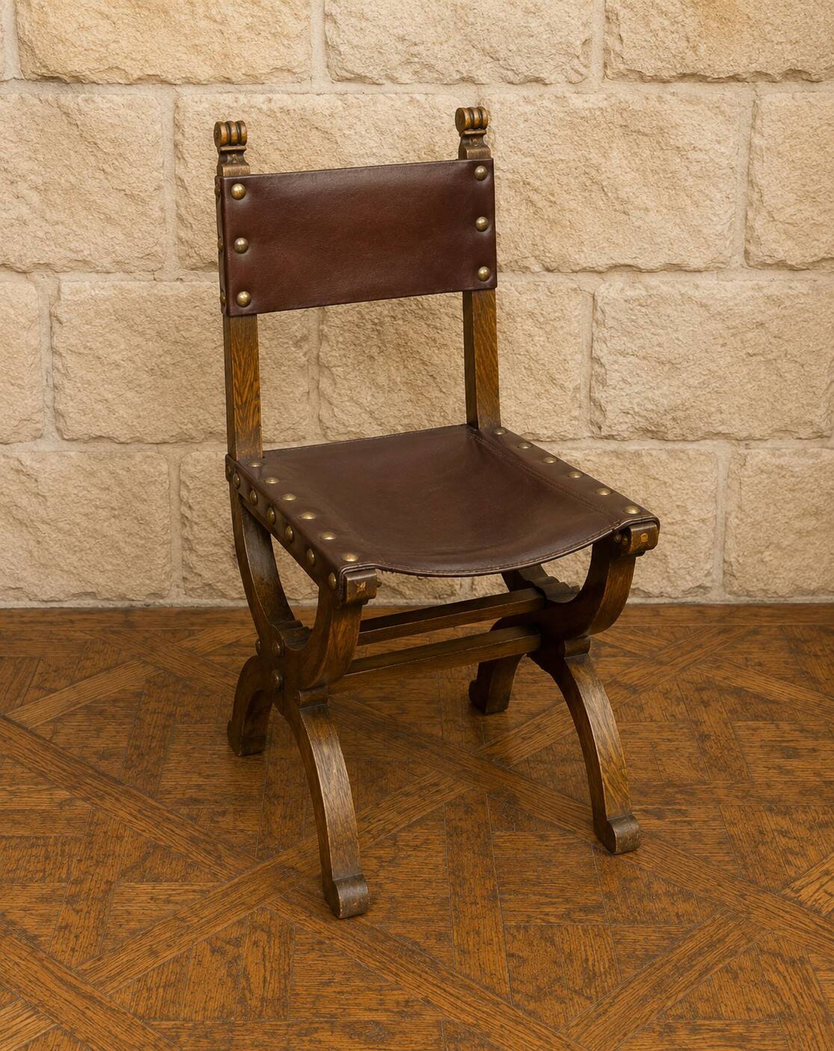Set of six Renaissance-style chairs in oak and leather.