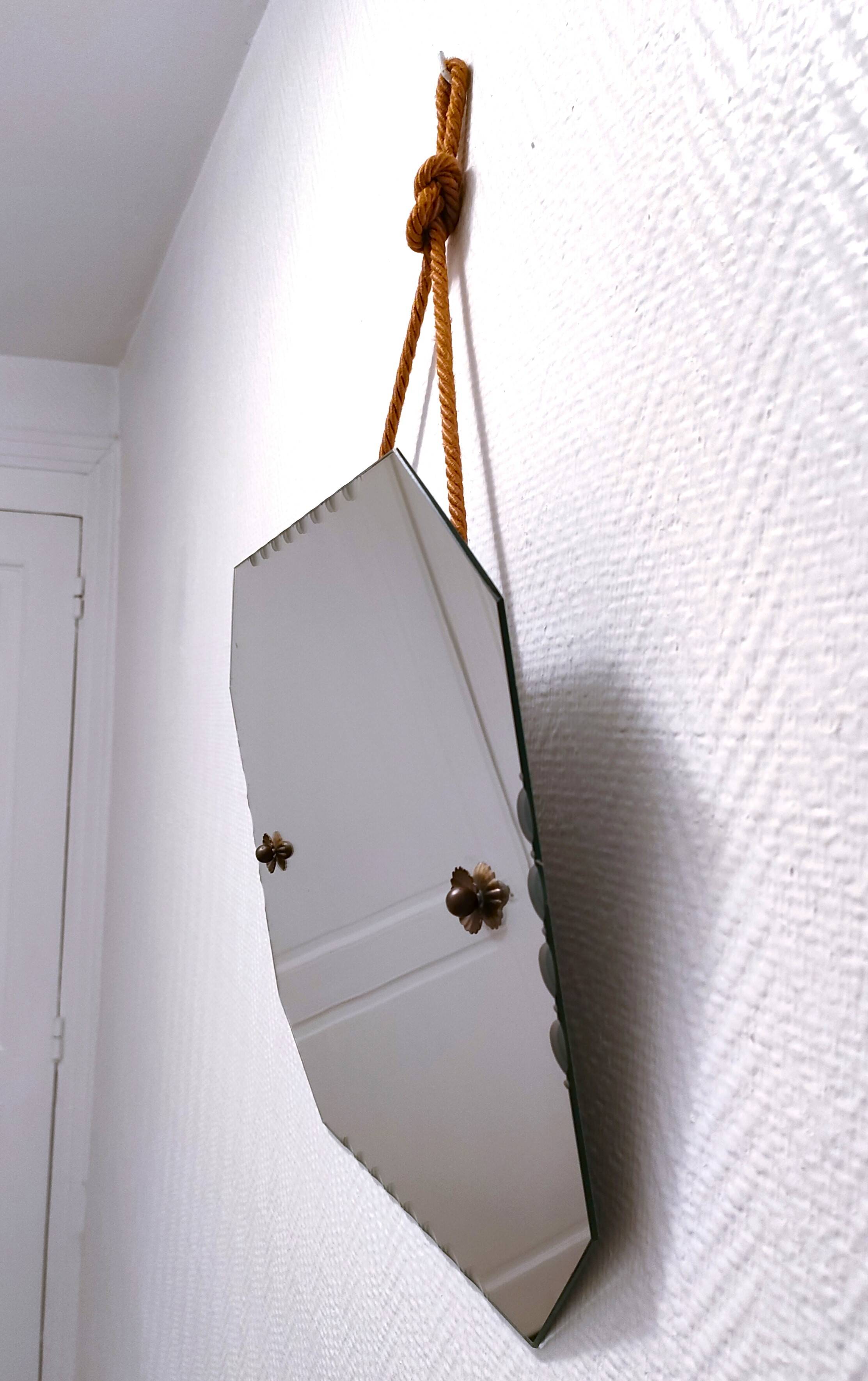 Octagonal mirror with brass hubcaps from the 60s