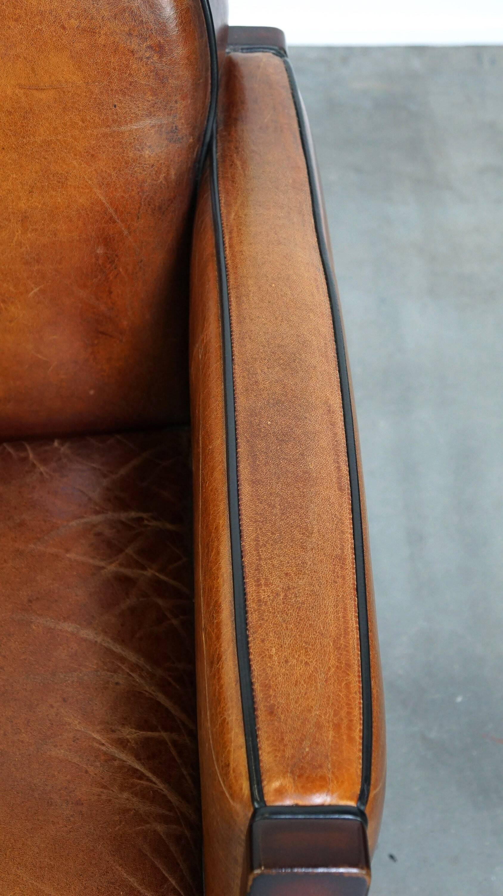 Sheepskin Art Deco design armchair with wood and beautiful cognac-colored leather