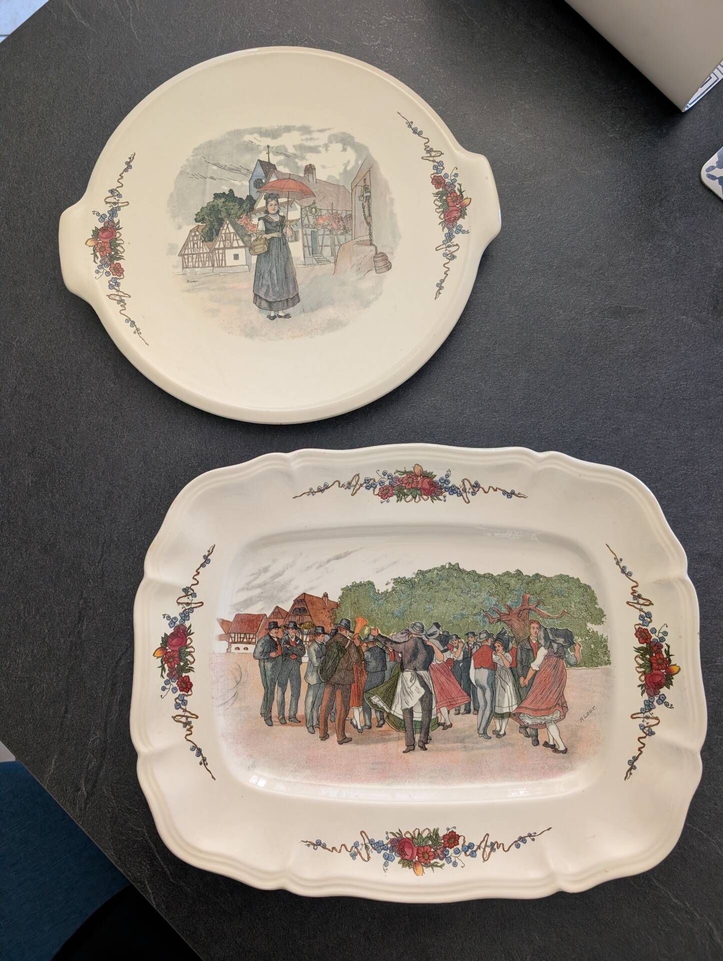 Two earthenware dishes from Obernai signed Henri Loux.