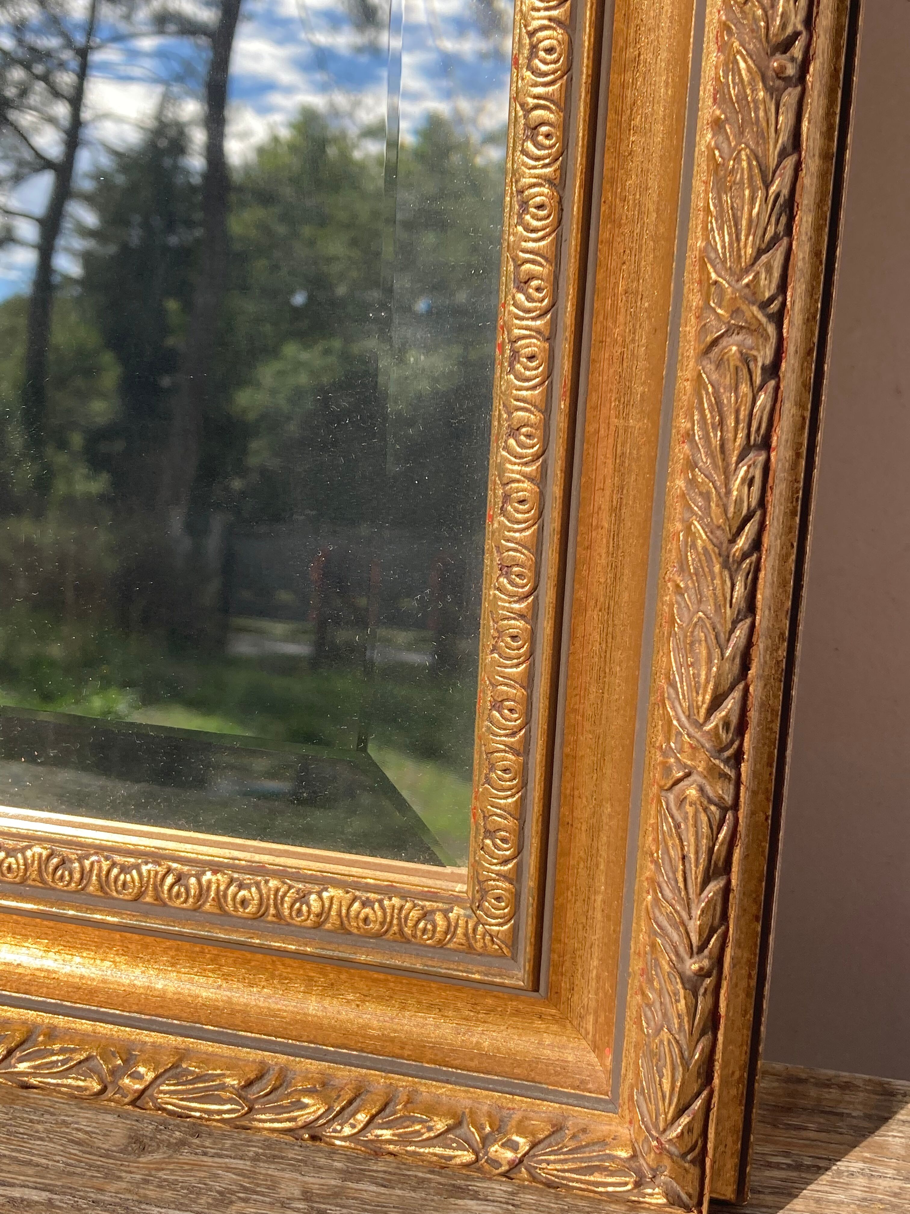Antique mirror in rectangular beveled gilded wood in Louis XVI style