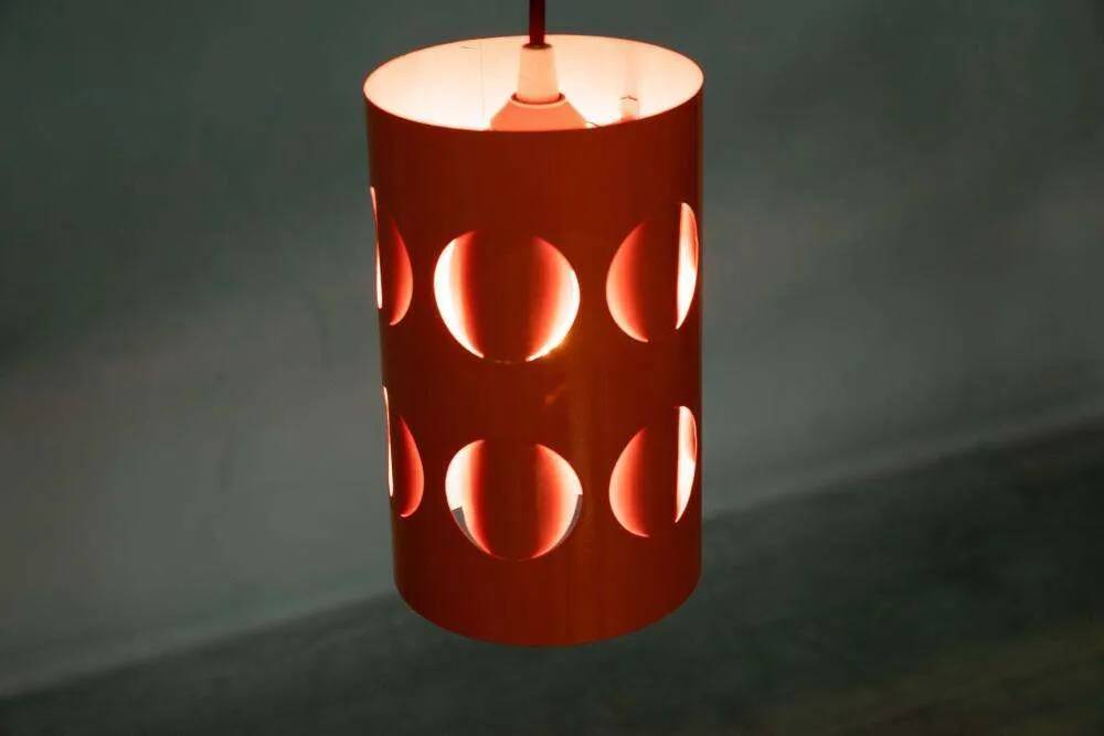 Vintage orange suspension light in a 1970s space age style.