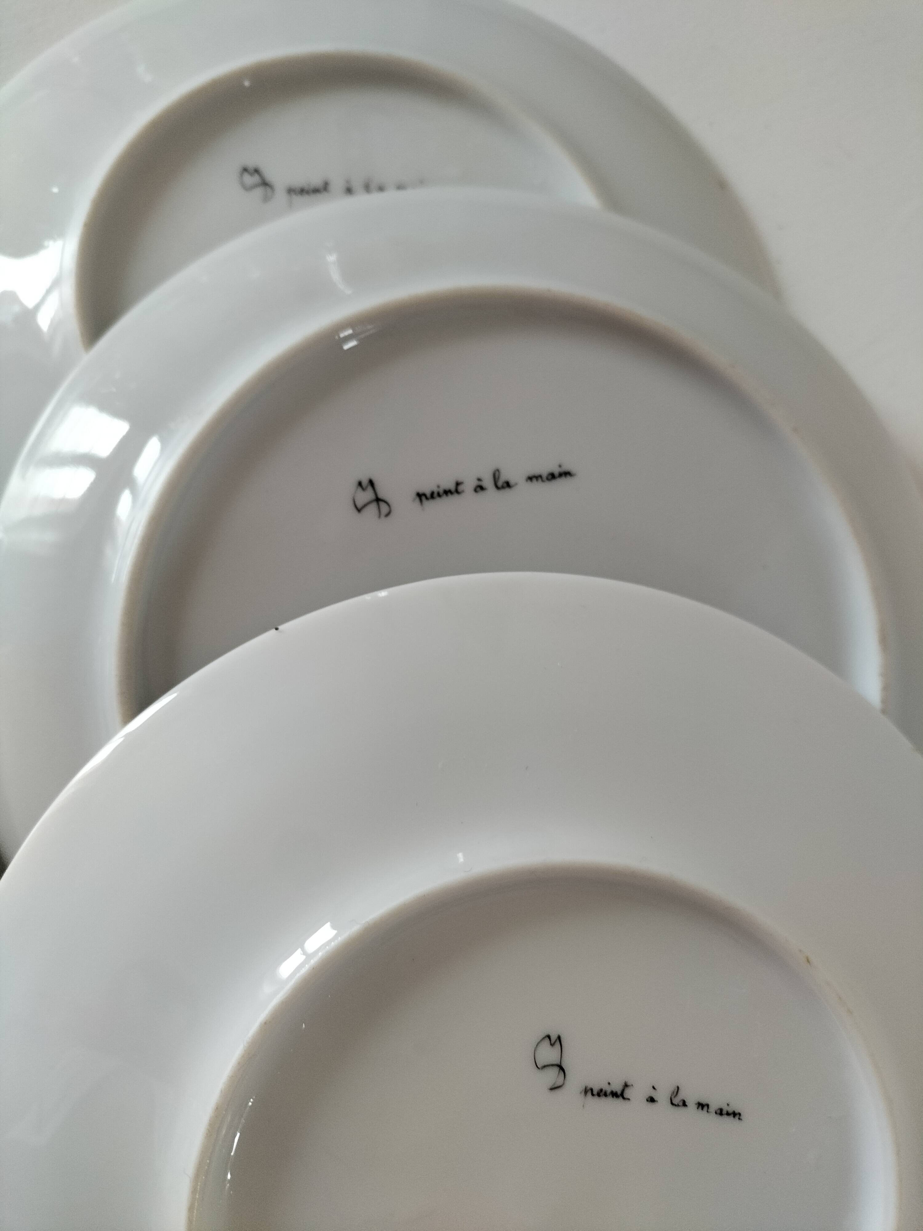 5 hand-painted dessert plates with stylised fruit designs.