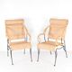 Pair of wicker and blackened iron armchairs