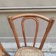 Pair of vintage bistro chairs in curved wood and caning.