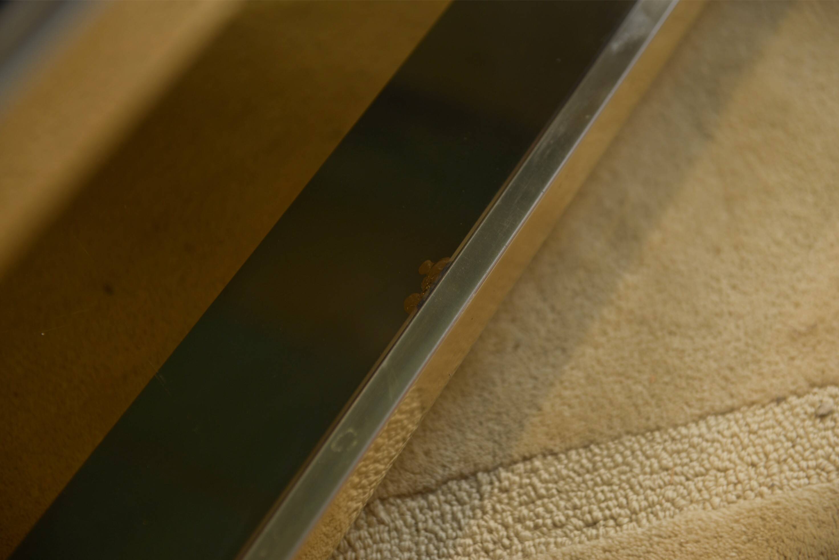 Hollywood Regency coffee table in smoked glass with mirrored framing from the 1970s.
