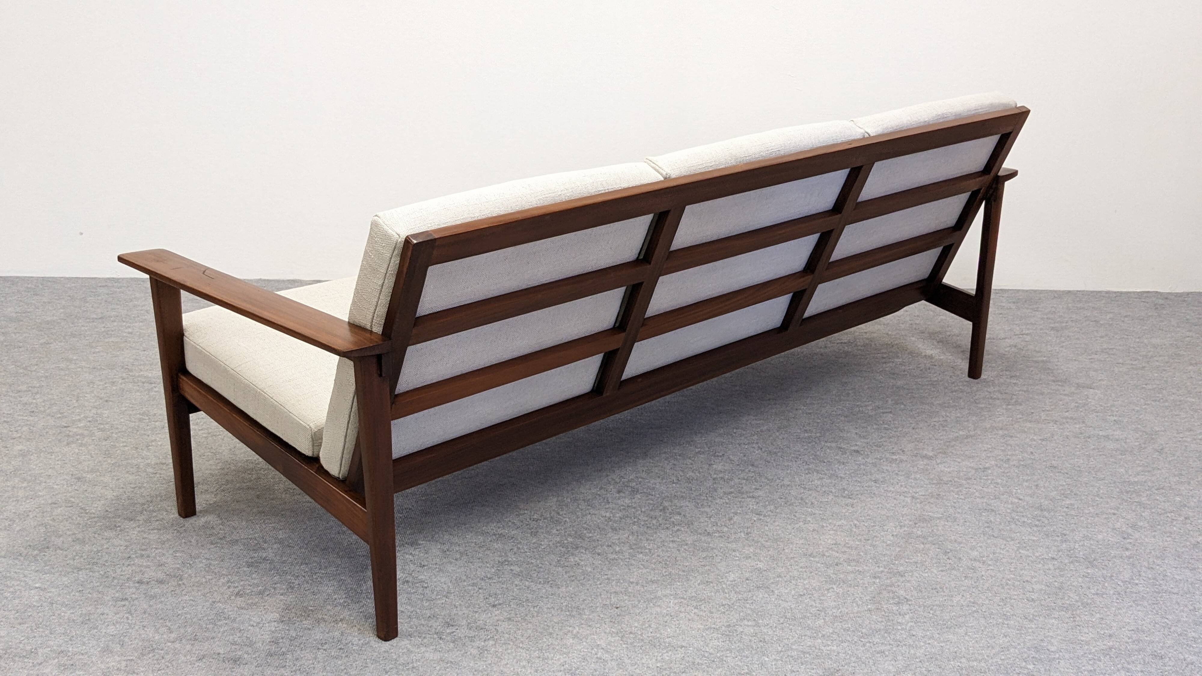 Scandinavian style three-seater sofa in teak, France circa 1950.