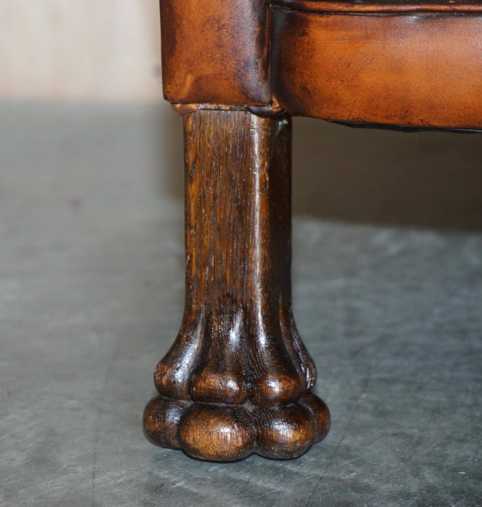 Victorian Chesterfield leather canapé with oak lion claw feet.