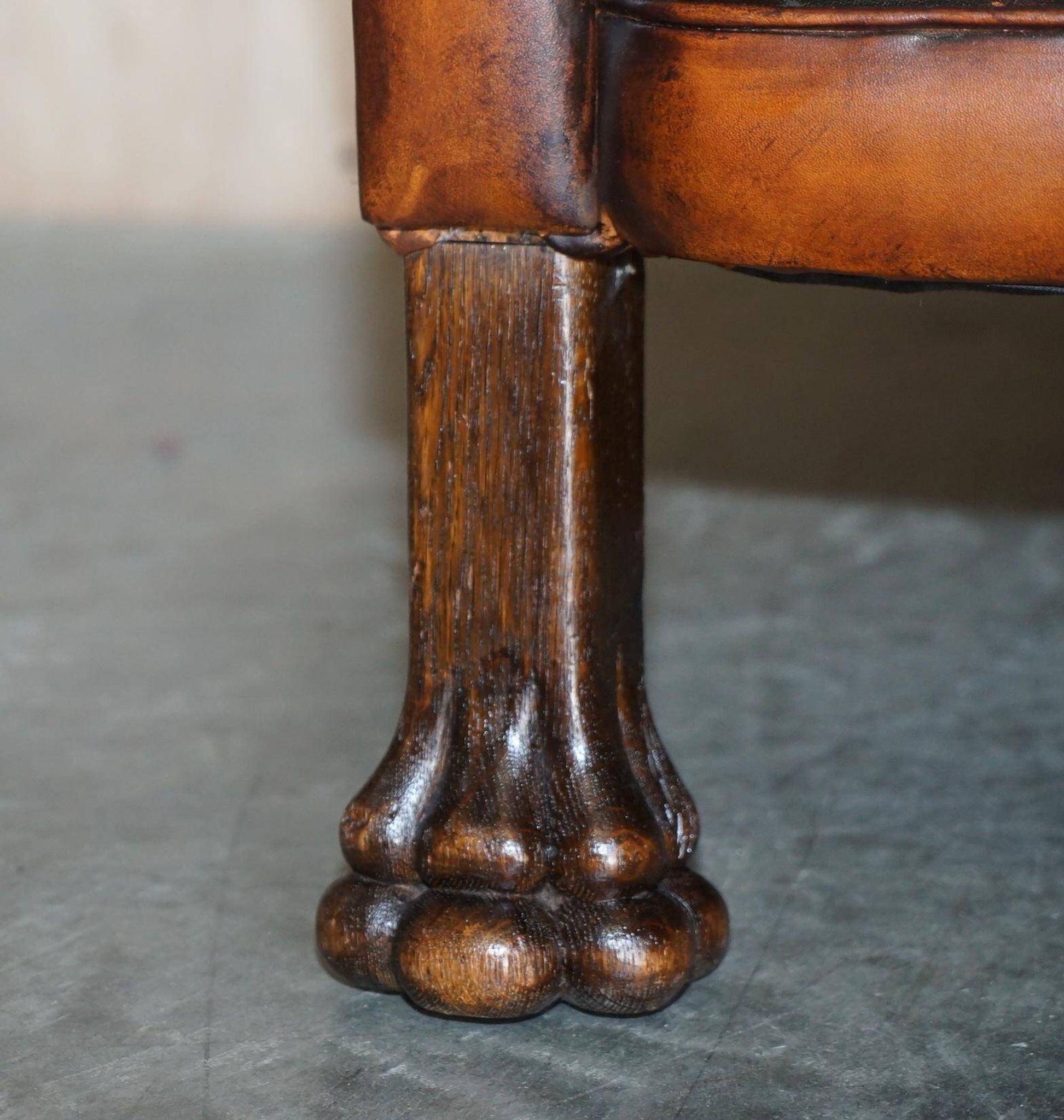 Victorian Chesterfield leather canapé with oak lion claw feet.